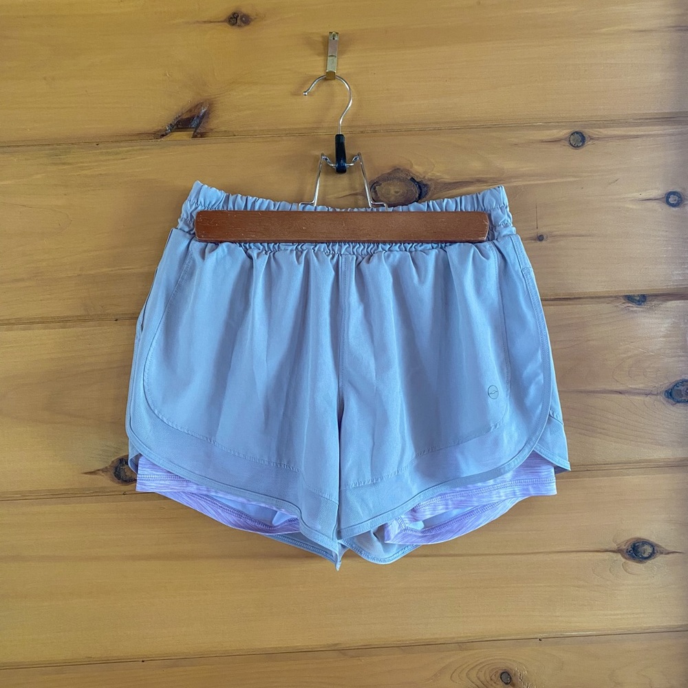 Gray shorts with purple spandex underneath
